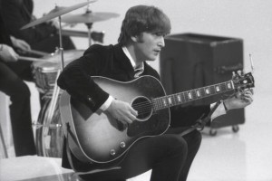 UNSPECIFIED - CIRCA 1960:  Photo of BEATLES and John LENNON; of the Beatles, tuning guitar (Gibson J160E acoustic) during the filming of "A Hard Day's Night" at the Scala Theatre  (Photo by Max Scheler - K & K/Redferns)